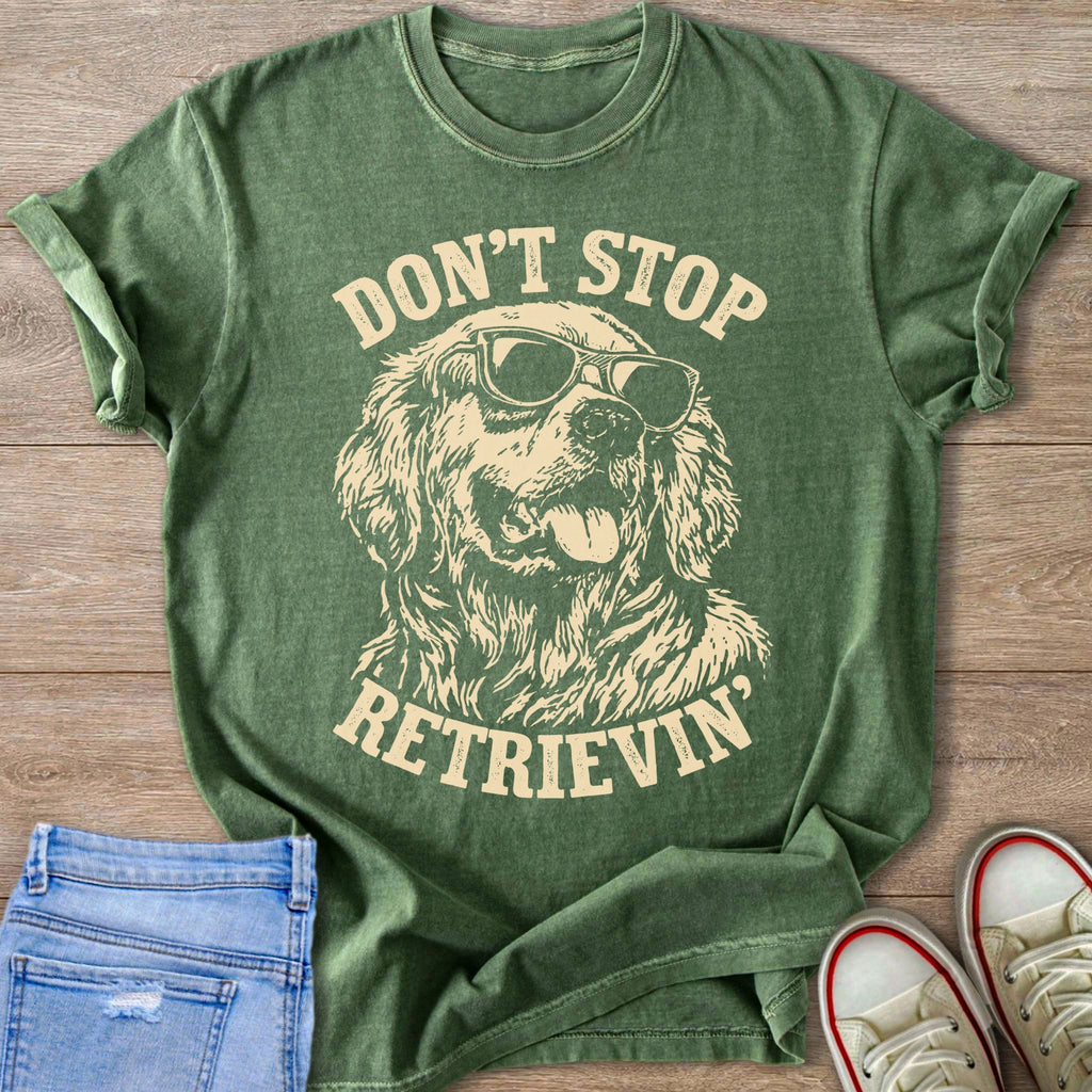 Green t-shirt with distressed graphic of a golden retriever wearing sunglasses and text "DON'T STOP. RETRIEVIN'."