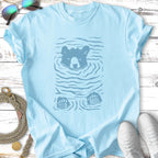 Light blue t-shirt with a blue graphic of a bear's head and paws in water.