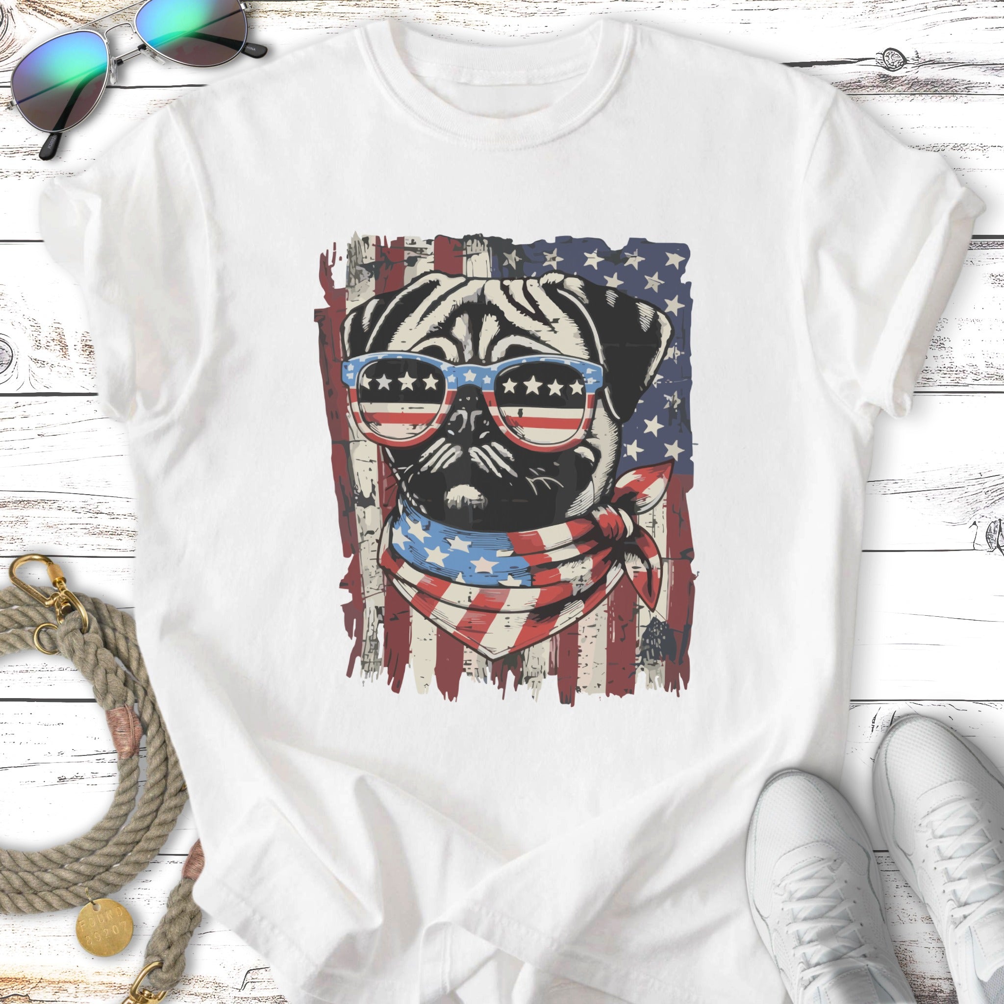 Pug wearing sunglasses and bandana against American flag background.