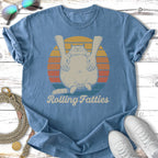 T-shirt with a cartoon cat being hugged, with text "Rolling Fatties".