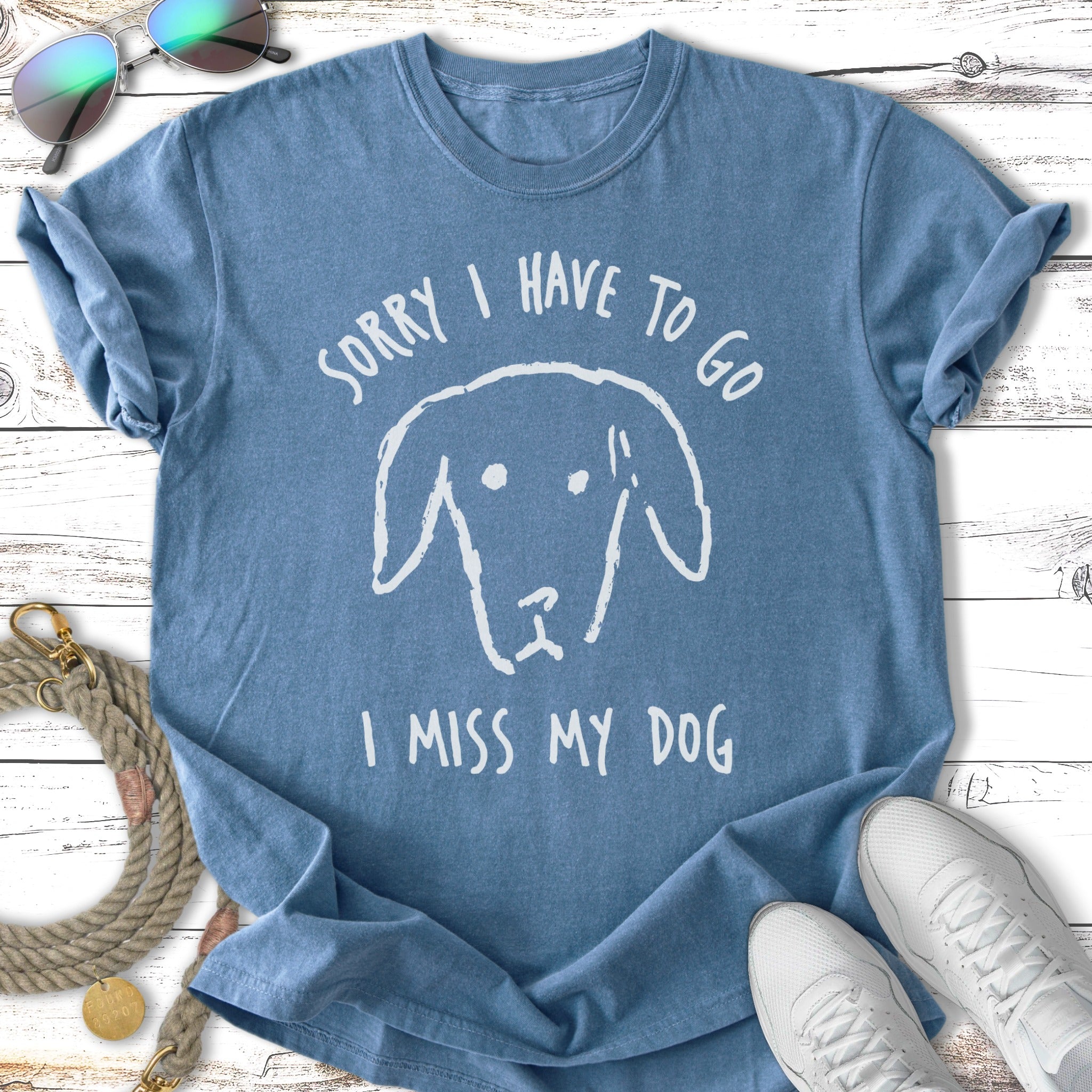 Blue t-shirt with white text and a dog drawing: "Sorry I Have to Go I Miss My Dog".