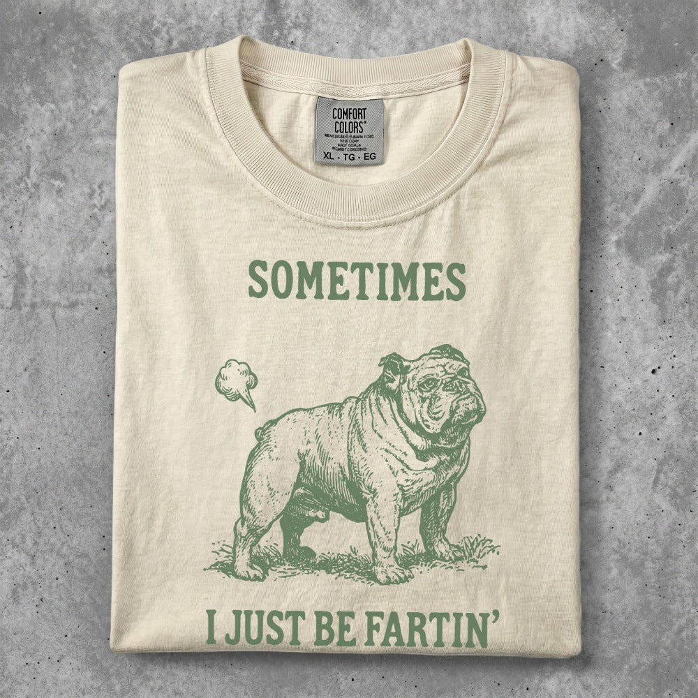 Cream t-shirt with a bulldog graphic and text "SOMETIMES I JUST BE FARTIN'".