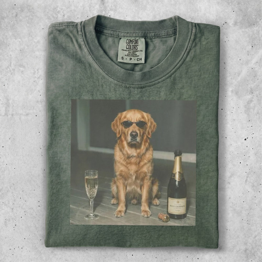 Golden retriever in sunglasses sits next to champagne and a glass.