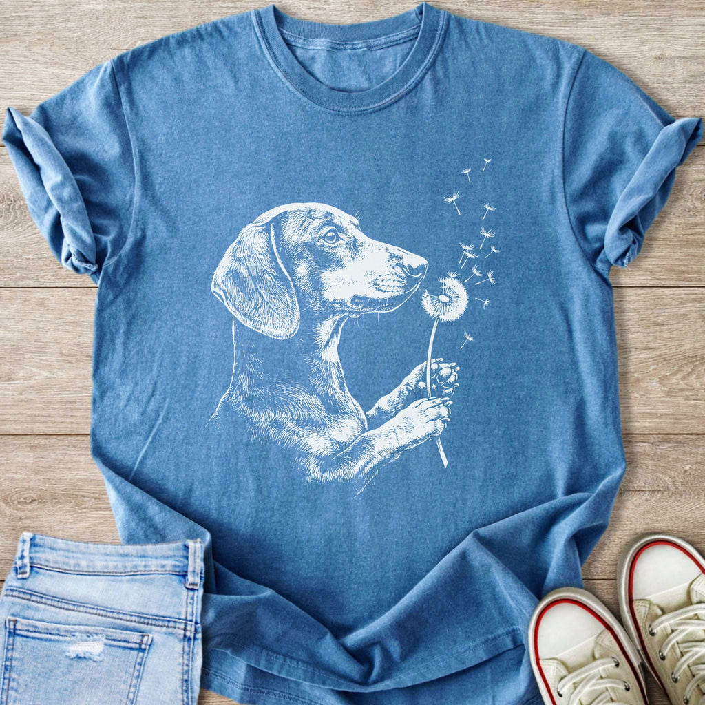 Blue t-shirt with white graphic of a dachshund holding a dandelion.