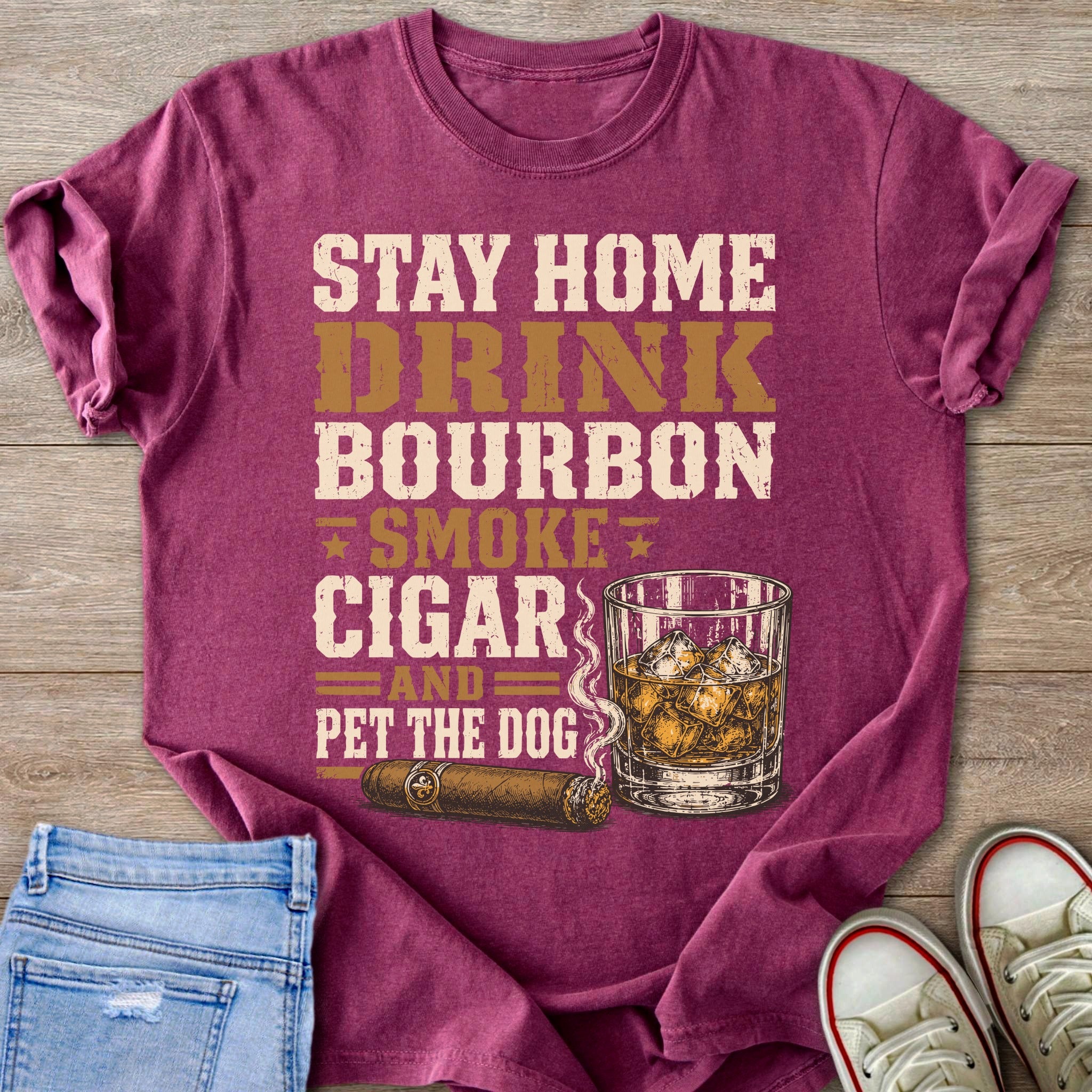 Maroon t-shirt with text "STAY HOME DRINK BOURBON SMOKE CIGAR AND PET THE DOG".