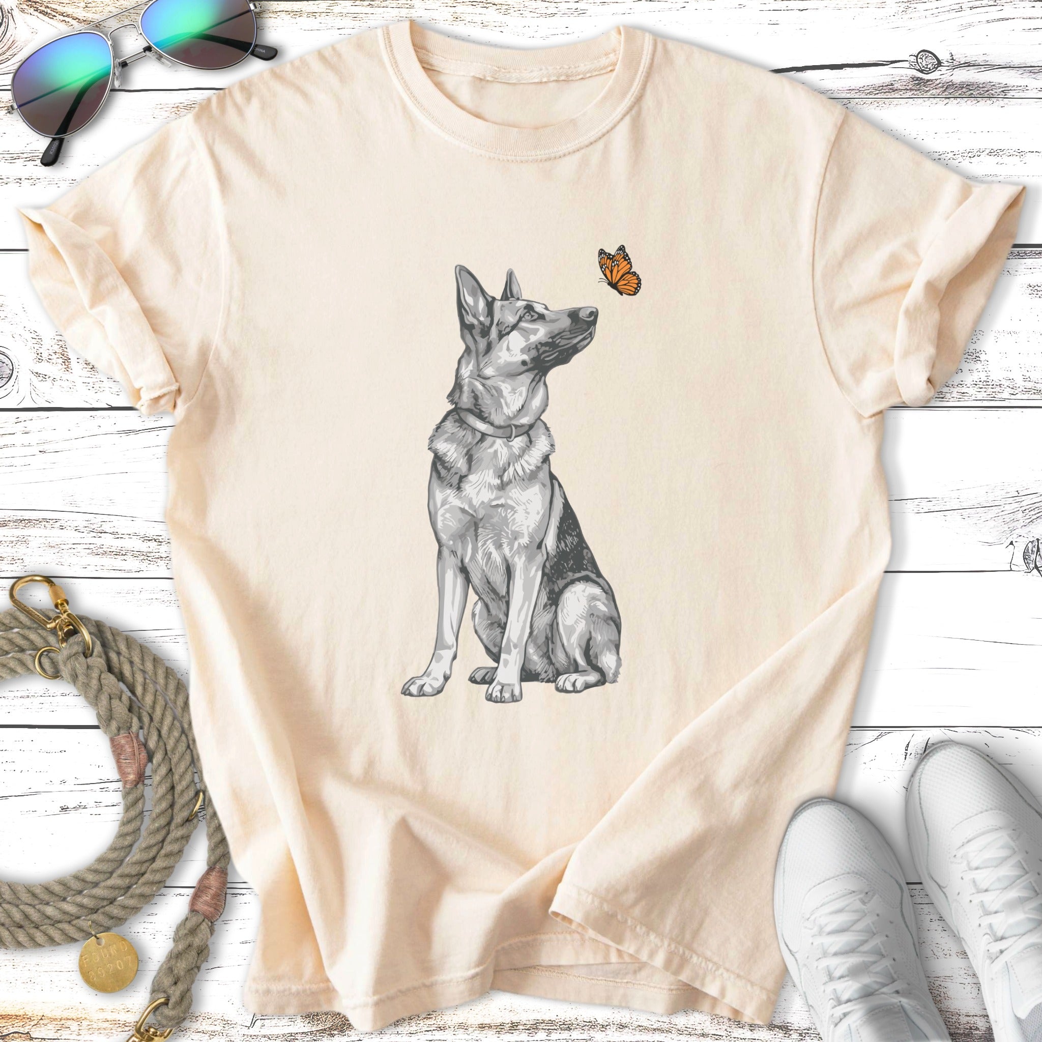 Sketch of a German Shepherd sitting with a butterfly on its nose.