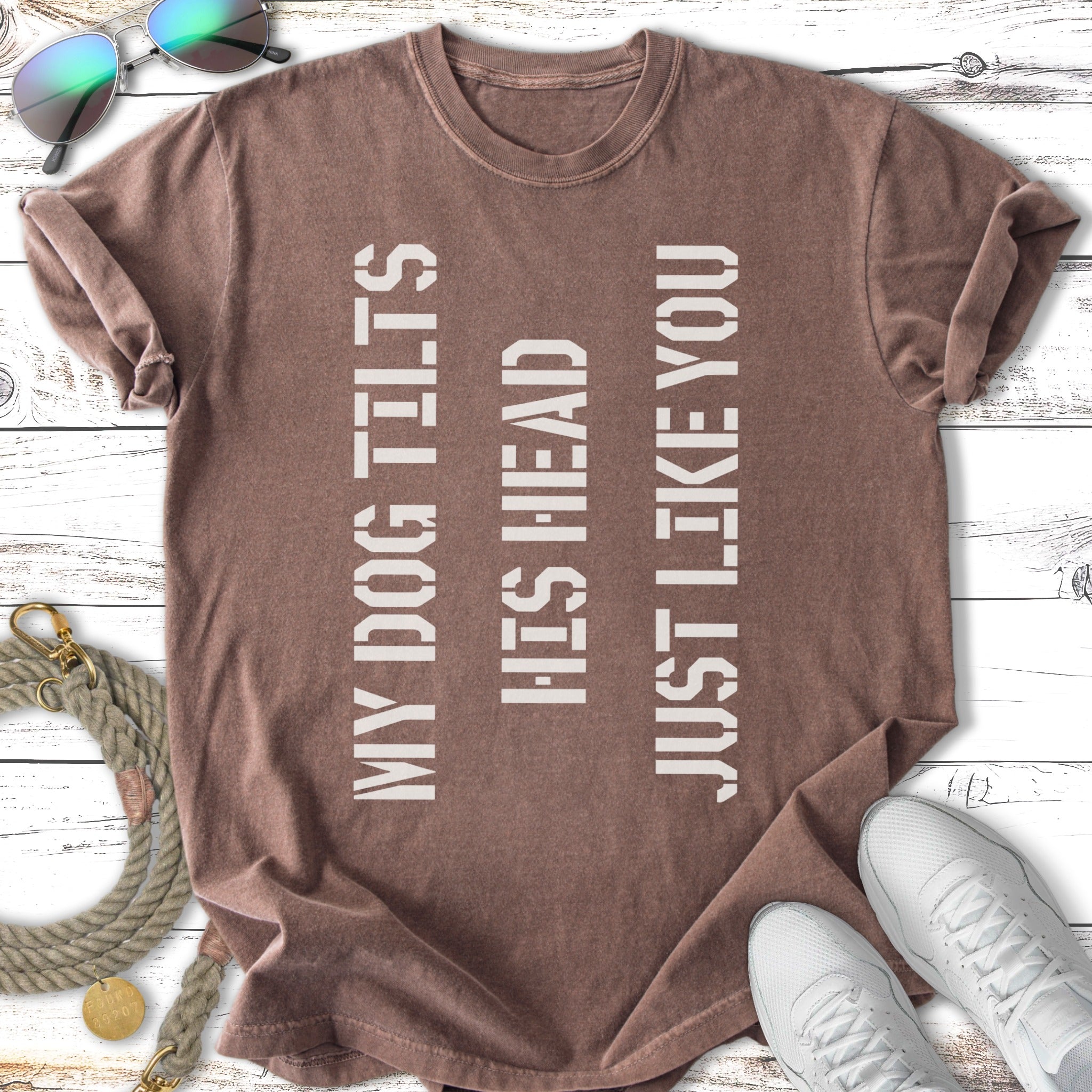 Brown t-shirt with text "MY DOG TILTS HIS HEAD JUST LIKE YOU" in white.