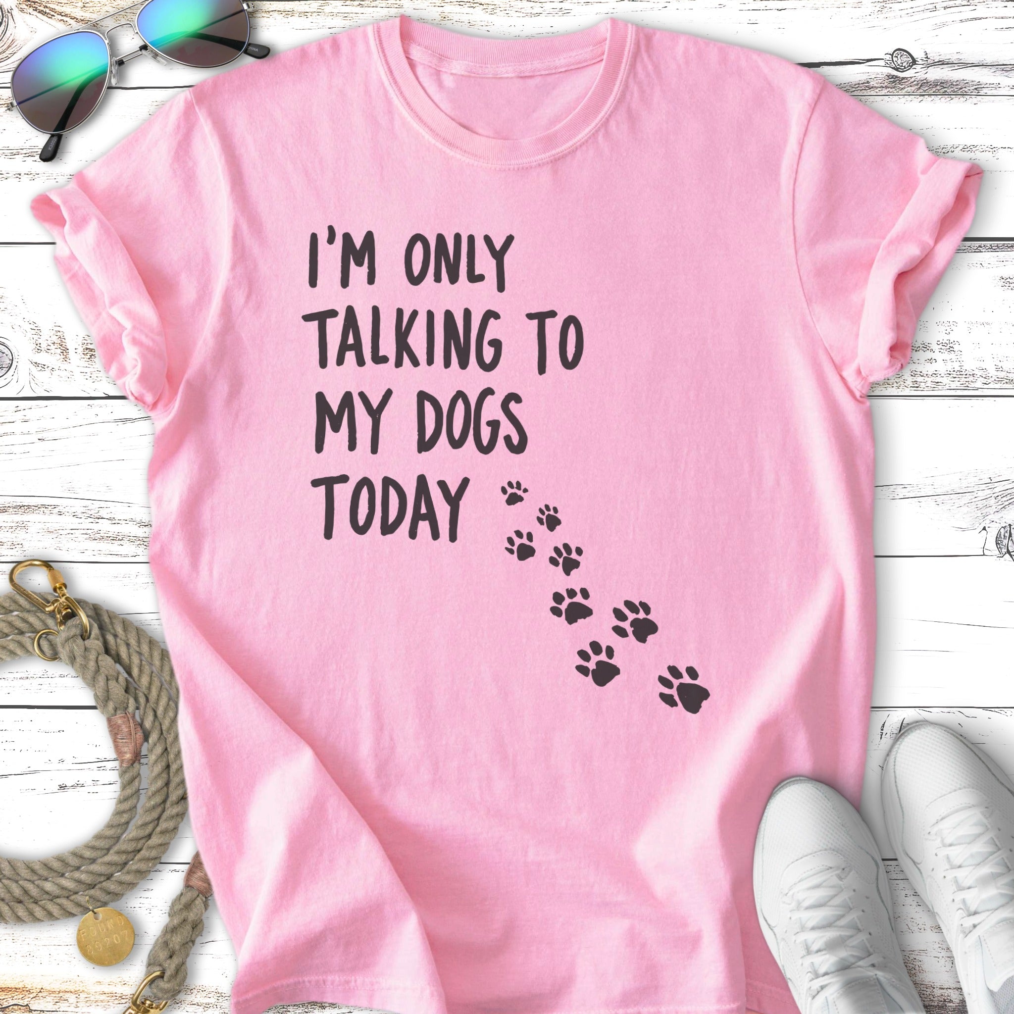 Pink t-shirt with black paw prints and "I'm only talking to my dogs today" text.
