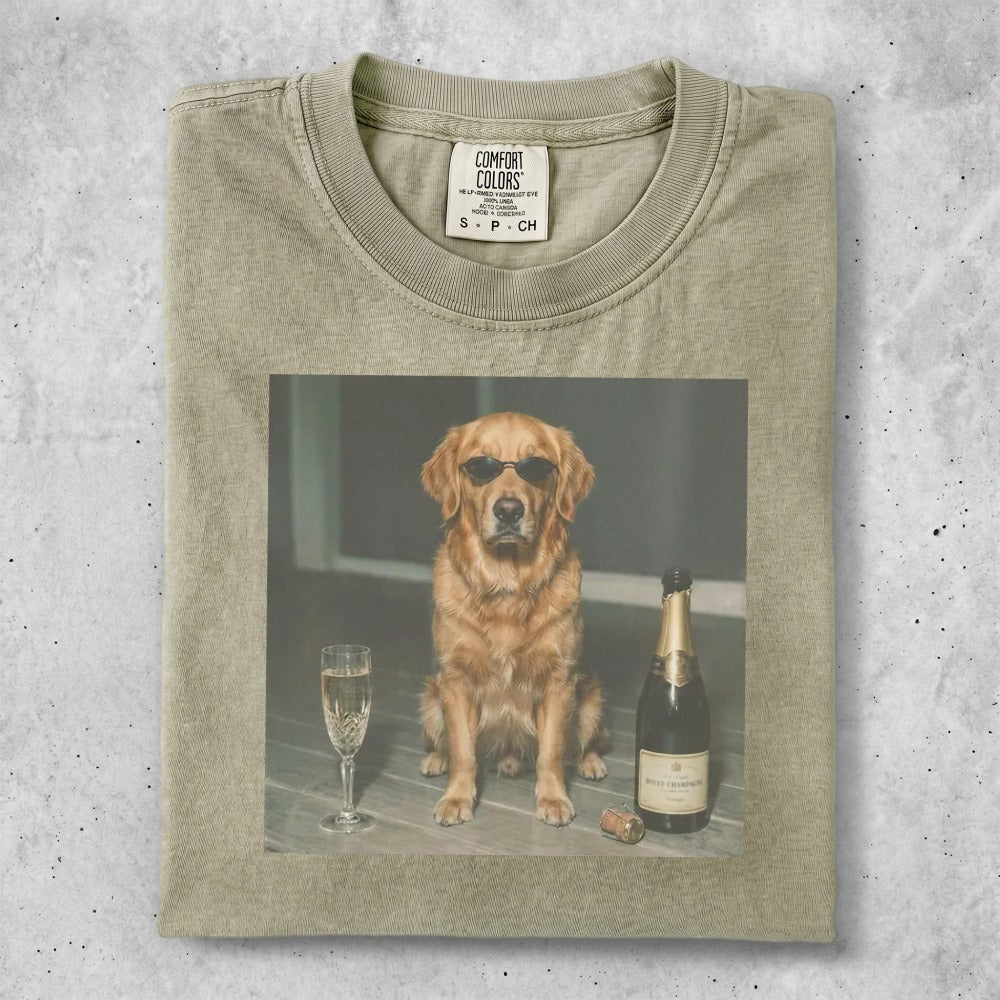 Golden retriever in sunglasses sits with champagne and glass.