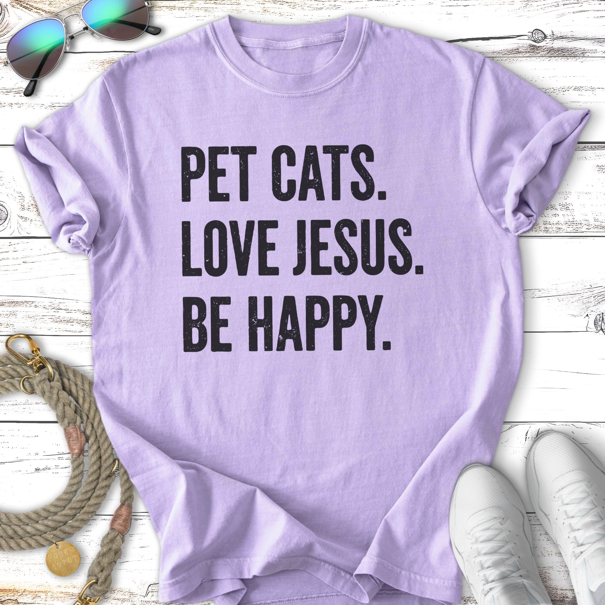 Purple t-shirt with "PET CATS. LOVE JESUS. BE HAPPY." text.