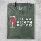 Green t-shirt with red wine glass graphic and text "I JUST WANT TO DRINK WINE AND PET MY DOG."