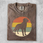 Brown t-shirt with a silhouette of a dog in a retro sunset circle graphic.
