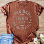 T-shirt with "FUR DAD THE MAN THE MYTH THE SNACK DEALER" text and paw prints.