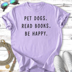 Lavender t-shirt with "PET DOGS. READ BOOKS. BE HAPPY." in black text.