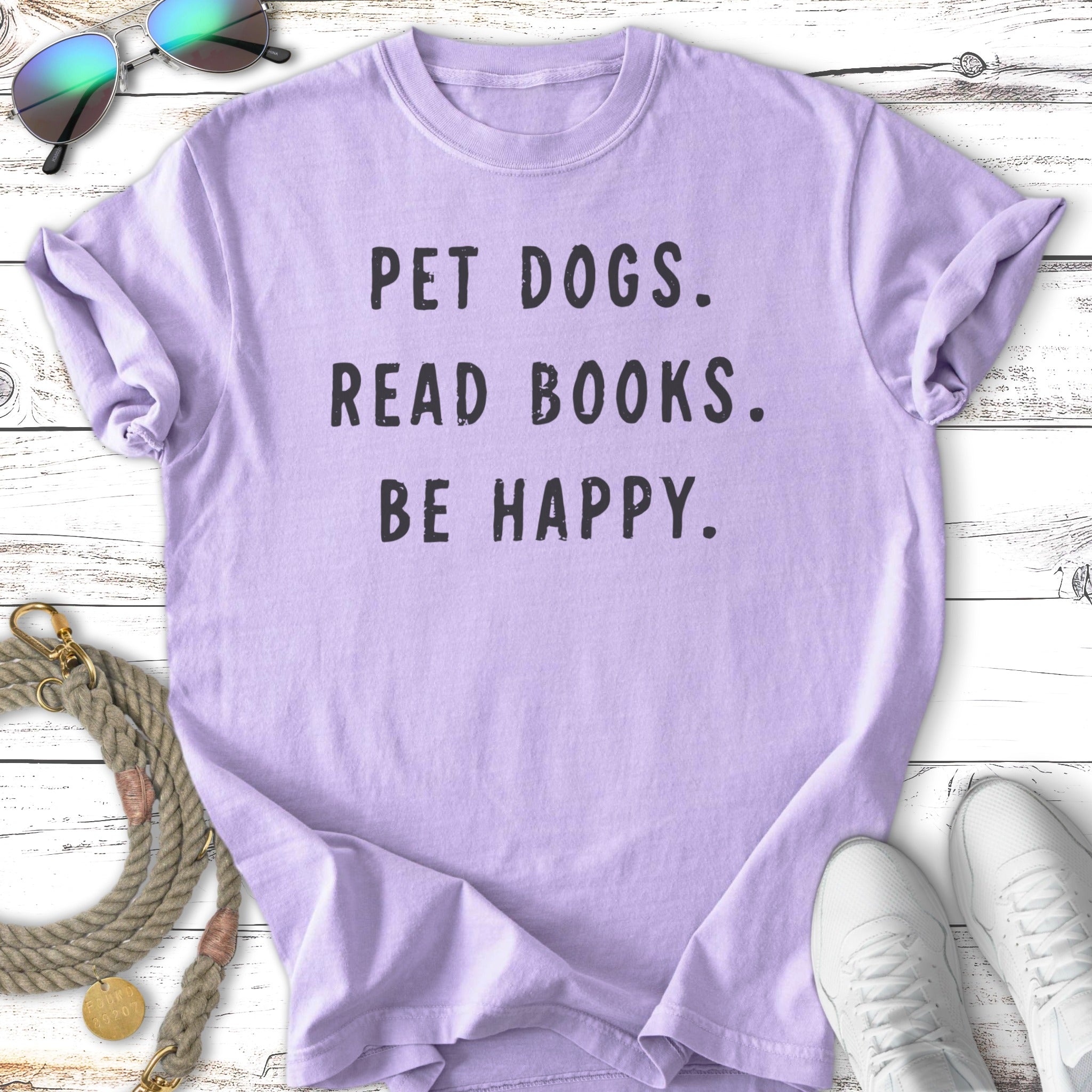 Lavender t-shirt with "PET DOGS. READ BOOKS. BE HAPPY." in black text.