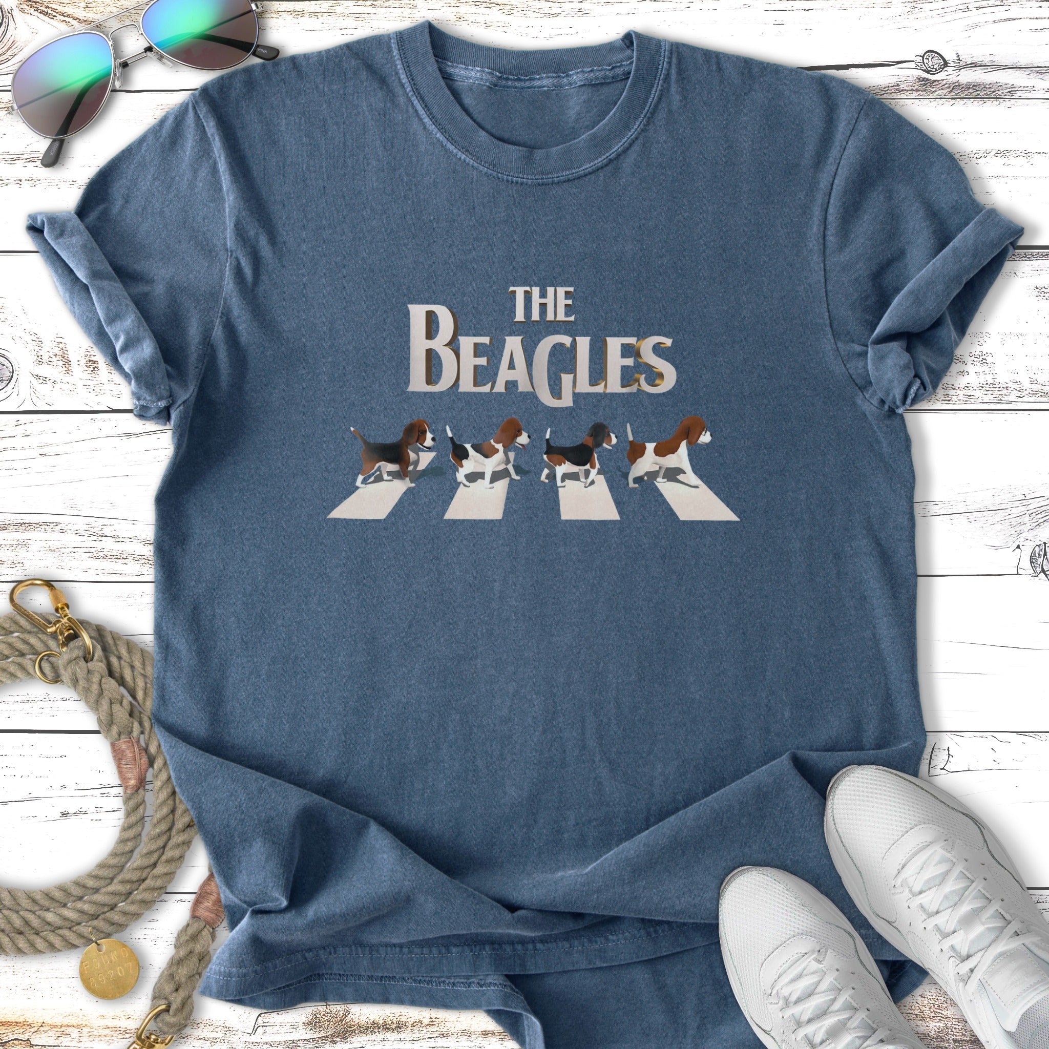 Four beagles walk across a crosswalk on a blue t-shirt design.