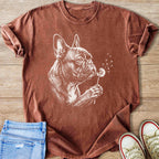 French bulldog with dandelion illustration on a rust-colored t-shirt.