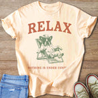 Peach t-shirt with "RELAX" and a dog in a lounge chair and "NOTHING IS UNDER CONT".