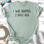 T-shirt with text "I WAS NORMAL 2 DOGS AGO" and dog leash.