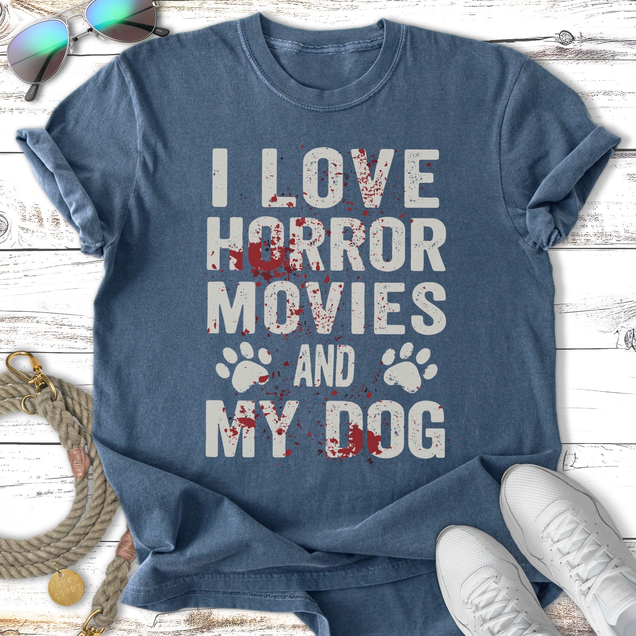 Blue t-shirt with text "I LOVE HORROR MOVIES AND MY DOG" and paw prints.
