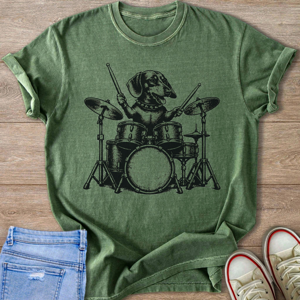 Dachshund playing a drum set on a green t-shirt.
