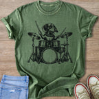Dachshund playing a drum set on a green t-shirt.