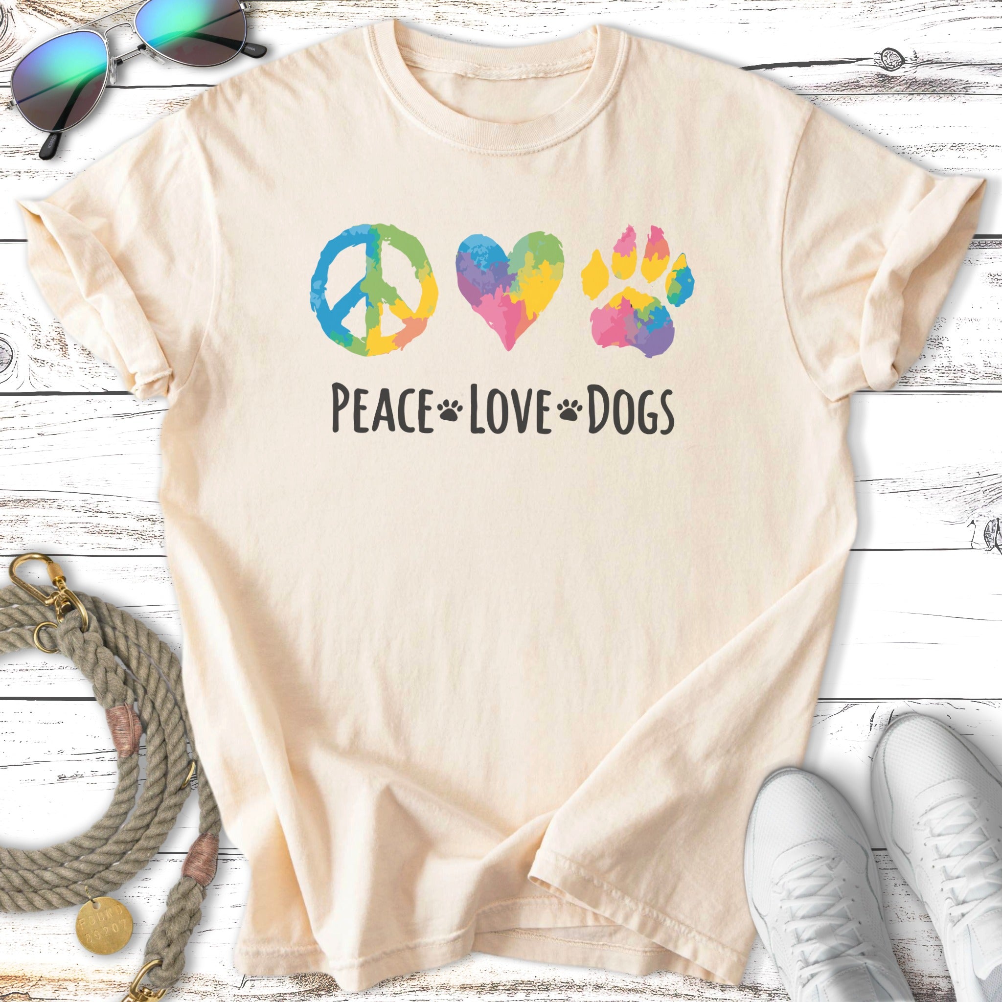 Cream t-shirt with peace sign, heart, and paw print graphic and "Peace Love Dogs" text.