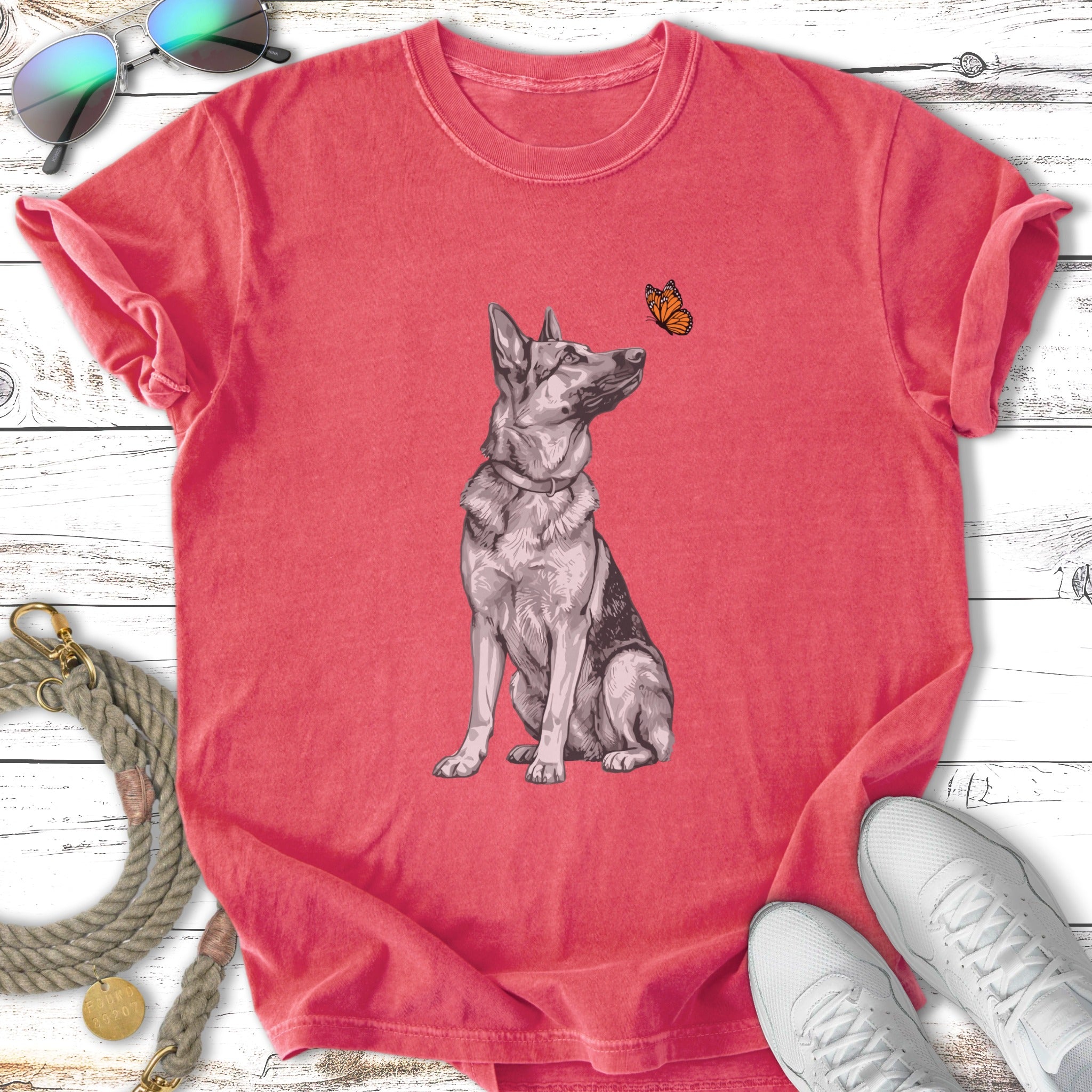 T-shirt with a sitting German Shepherd looking at a butterfly.
