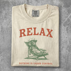 Cream t-shirt with "RELAX" and a dog on a lounge chair.