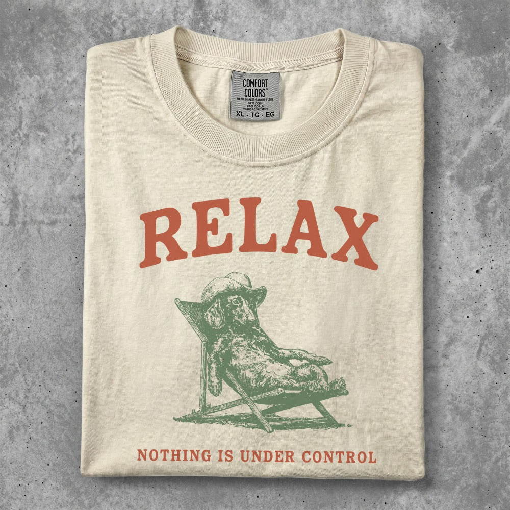 Cream t-shirt with "RELAX" and a dog on a lounge chair.