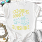 Iced coffee, dogs, and sunshine text on a t-shirt with sunglasses.