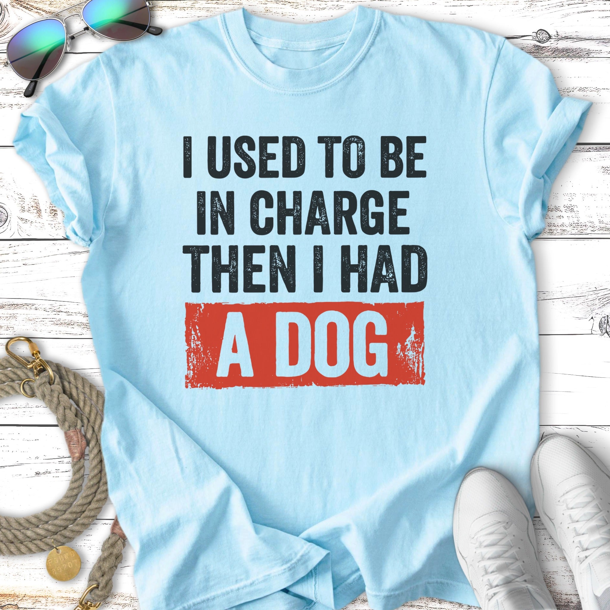 Light blue t-shirt with "I used to be in charge then I had a dog" slogan.