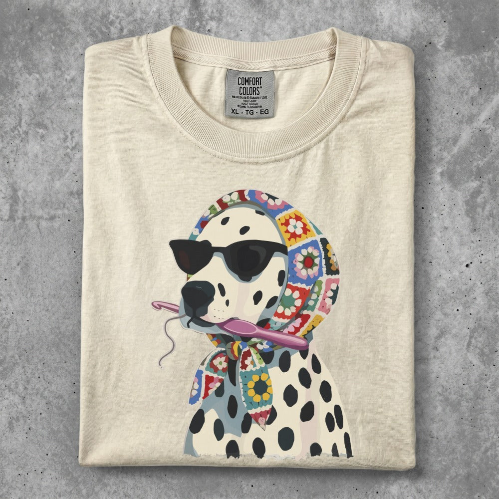 Cream t-shirt with a dalmatian wearing sunglasses and a crochet scarf.