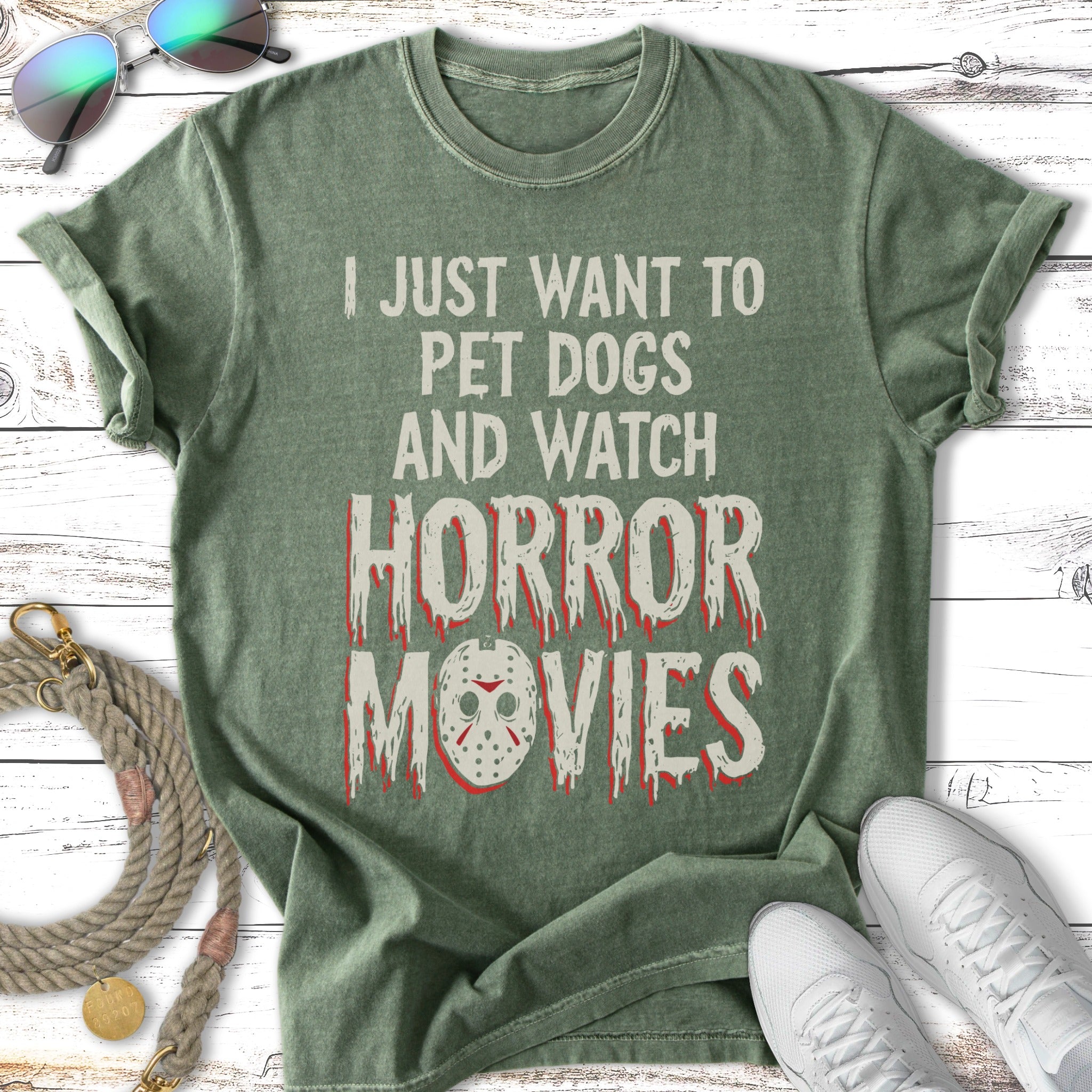Green t-shirt with text "I just want to pet dogs and watch horror movies" and a graphic.