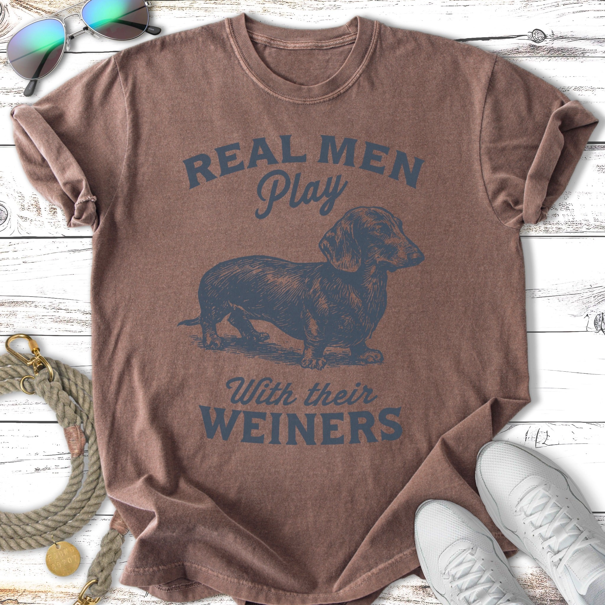T-shirt with a dachshund graphic and "Real Men Play With Their Weiners" text.