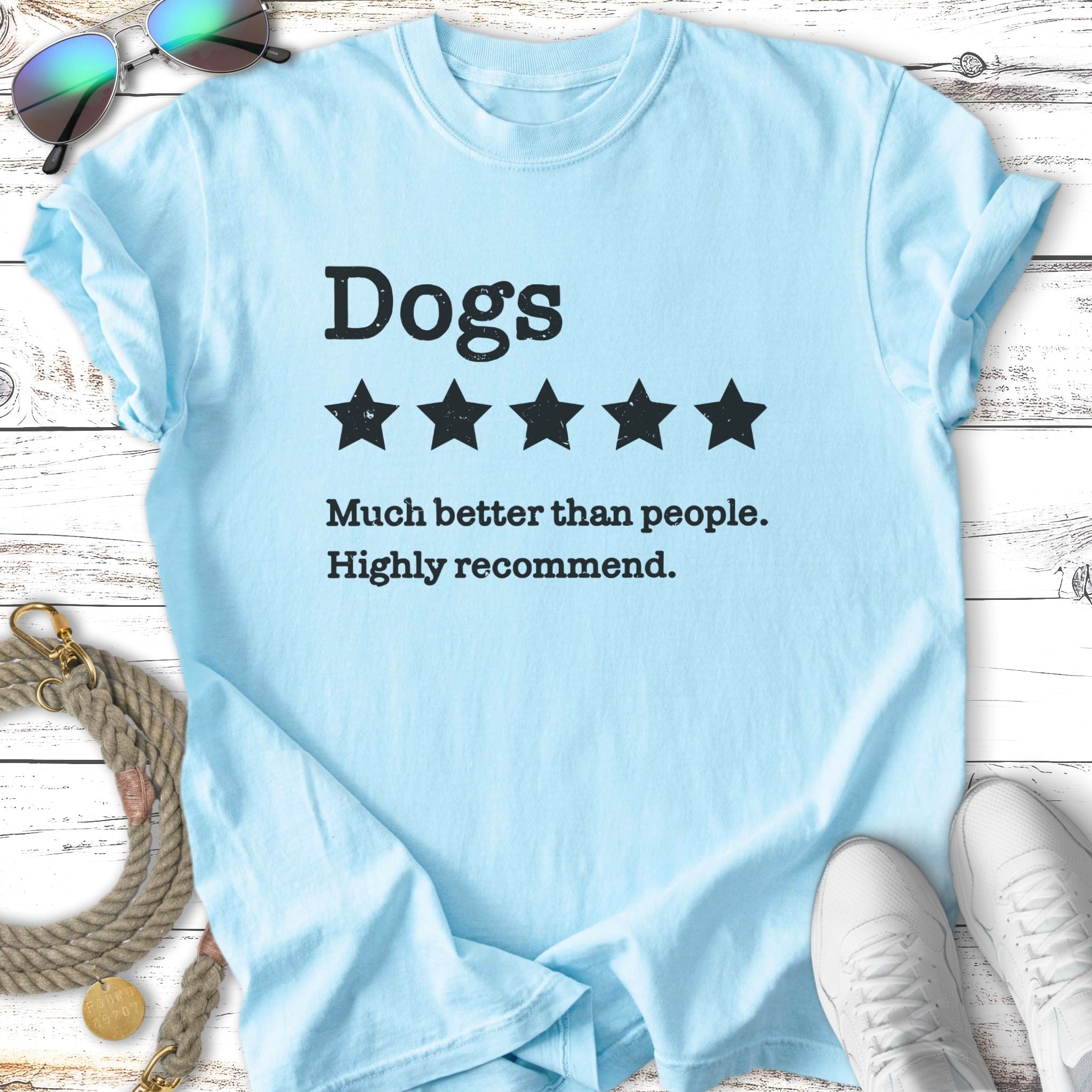 Light blue t-shirt with "Dogs. Much better than people. Highly recommend." and five stars.