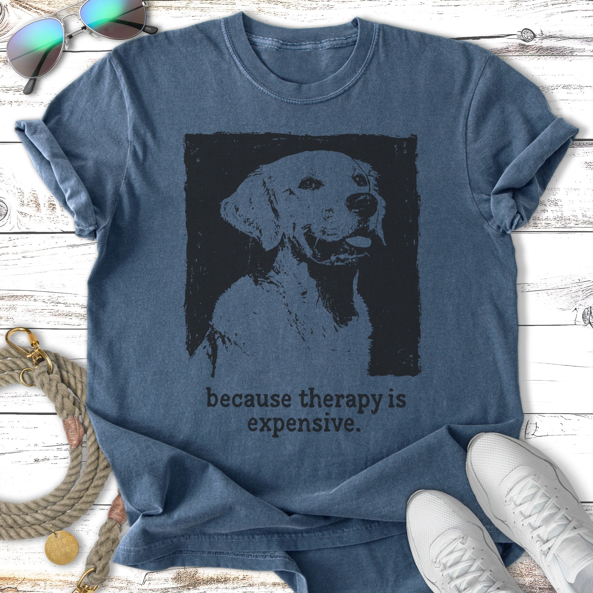 Dog graphic on a blue t-shirt that reads "because therapy is expensive."