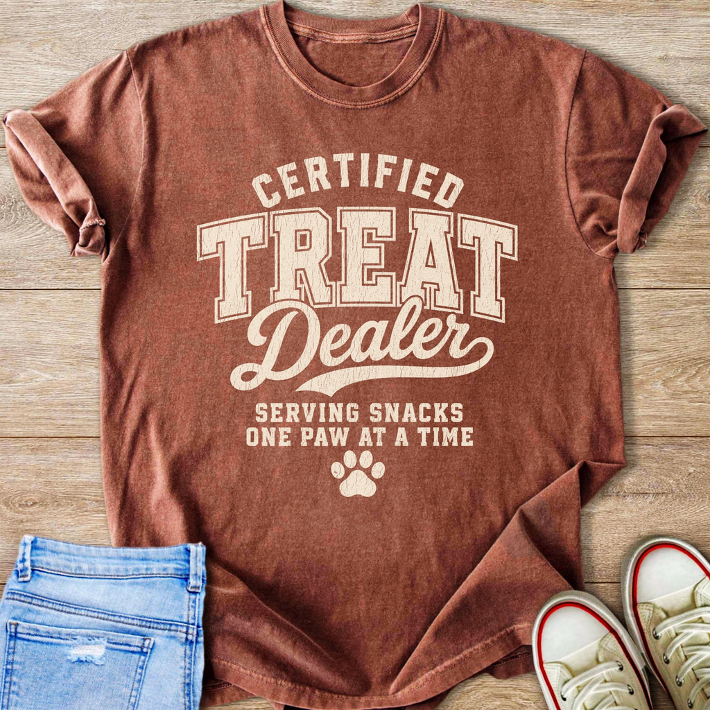T-shirt reading "Certified Treat Dealer Serving Snacks One Paw at a Time" with paw print.