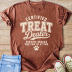 T-shirt reading "Certified Treat Dealer Serving Snacks One Paw at a Time" with paw print.
