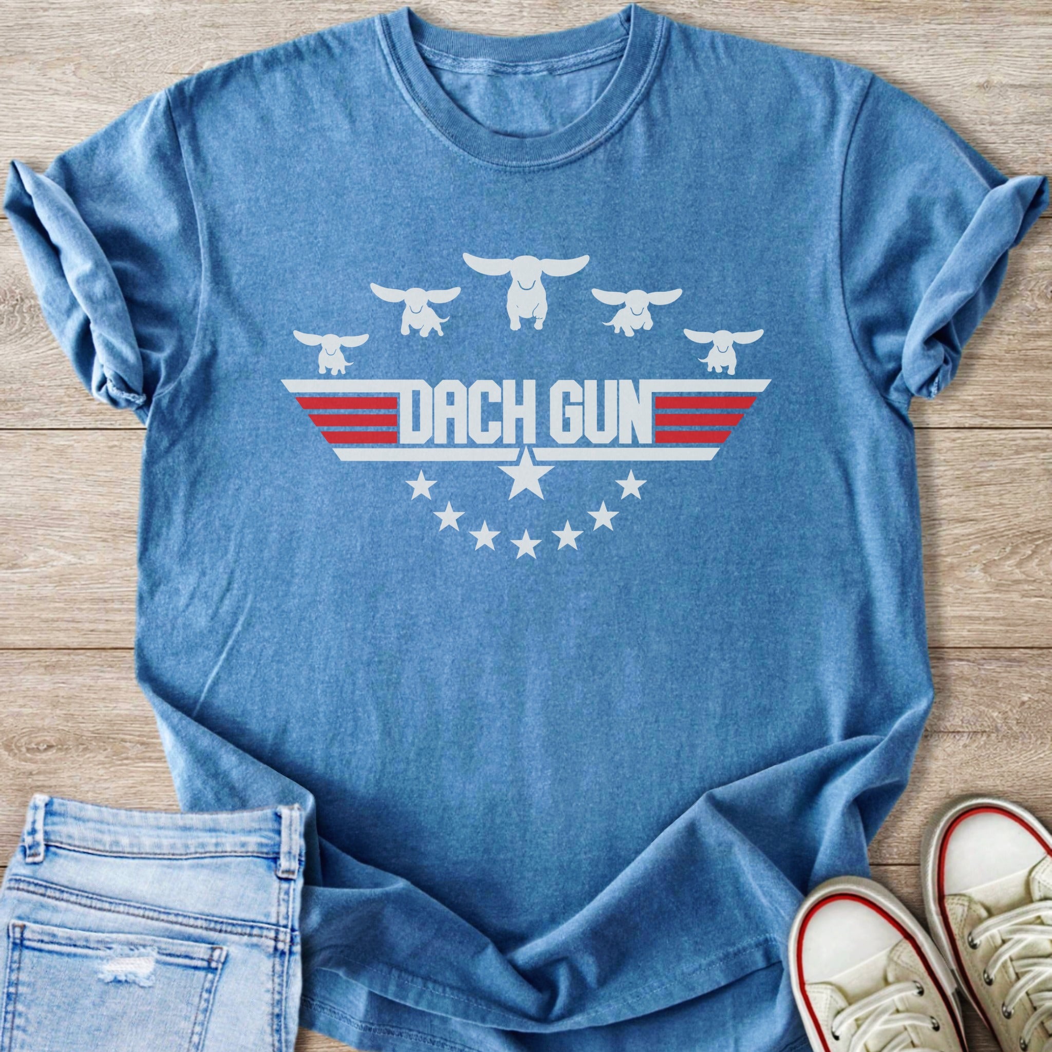 Blue t-shirt with "DACH GUN" text and stylized dachshunds and stars.