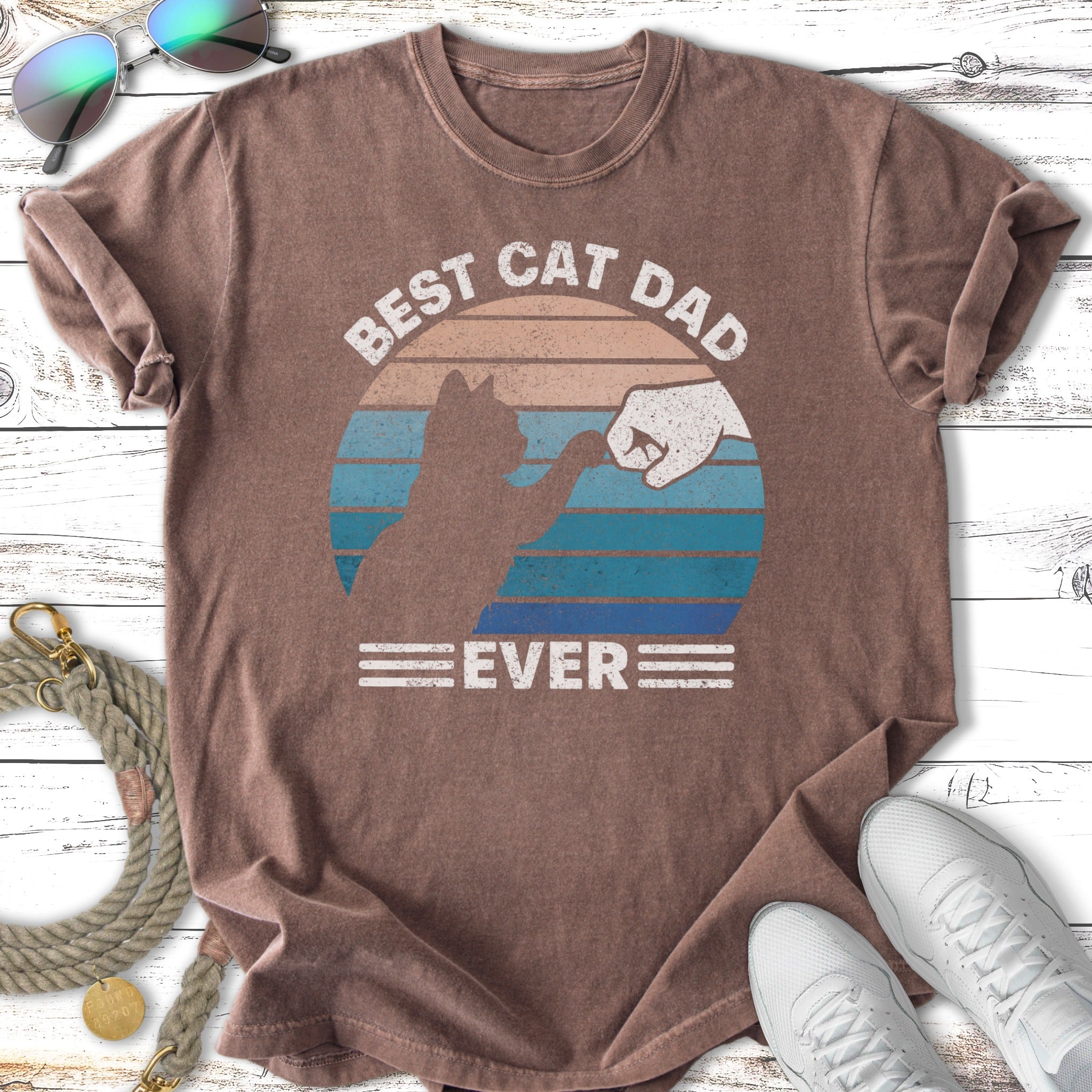 Brown t-shirt with "Best Cat Dad Ever" text and cat fist bump graphic.