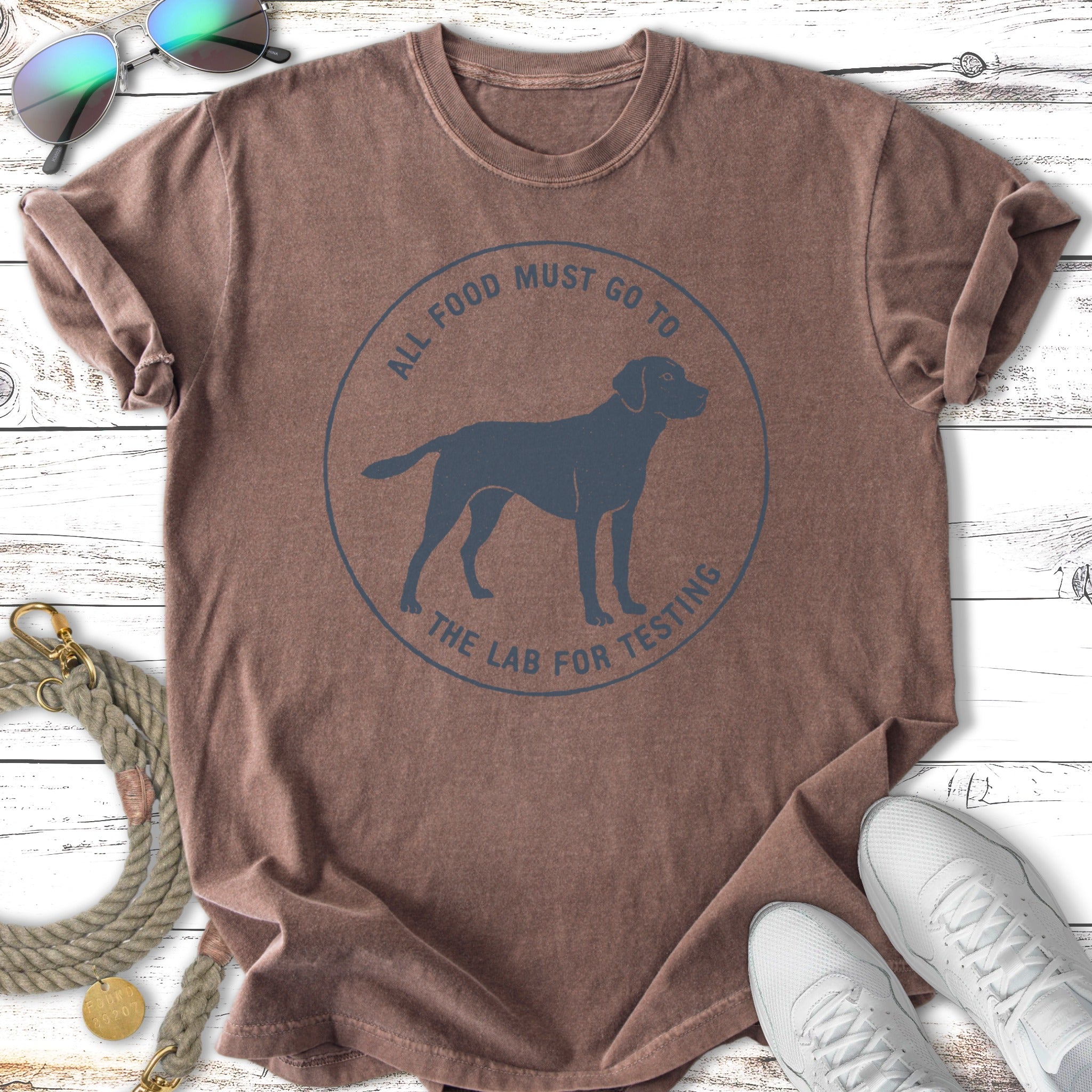Brown t-shirt with "All food must go to the lab for testing" graphic.