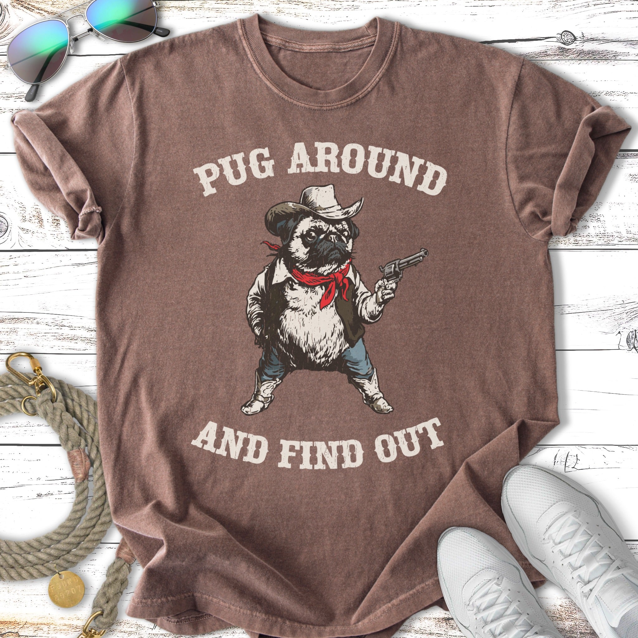 T-shirt with a pug in a cowboy hat and bandana holding a gun.