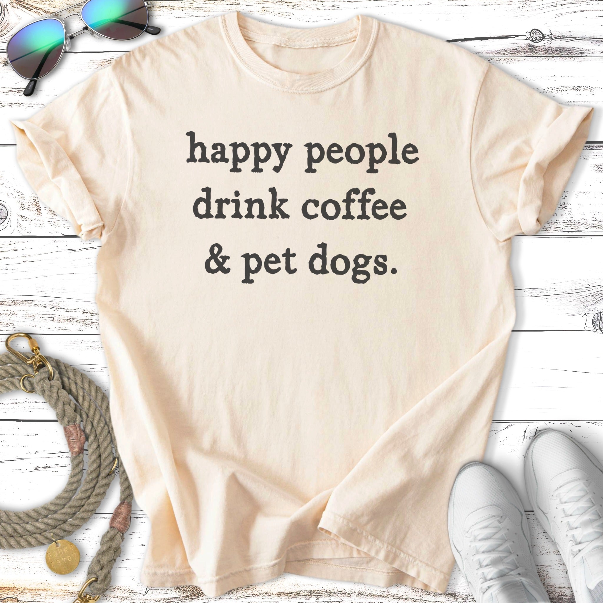 Cream t-shirt with black text "happy people drink coffee & pet dogs."