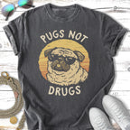 Pug wearing sunglasses with "Pugs Not Drugs" text.