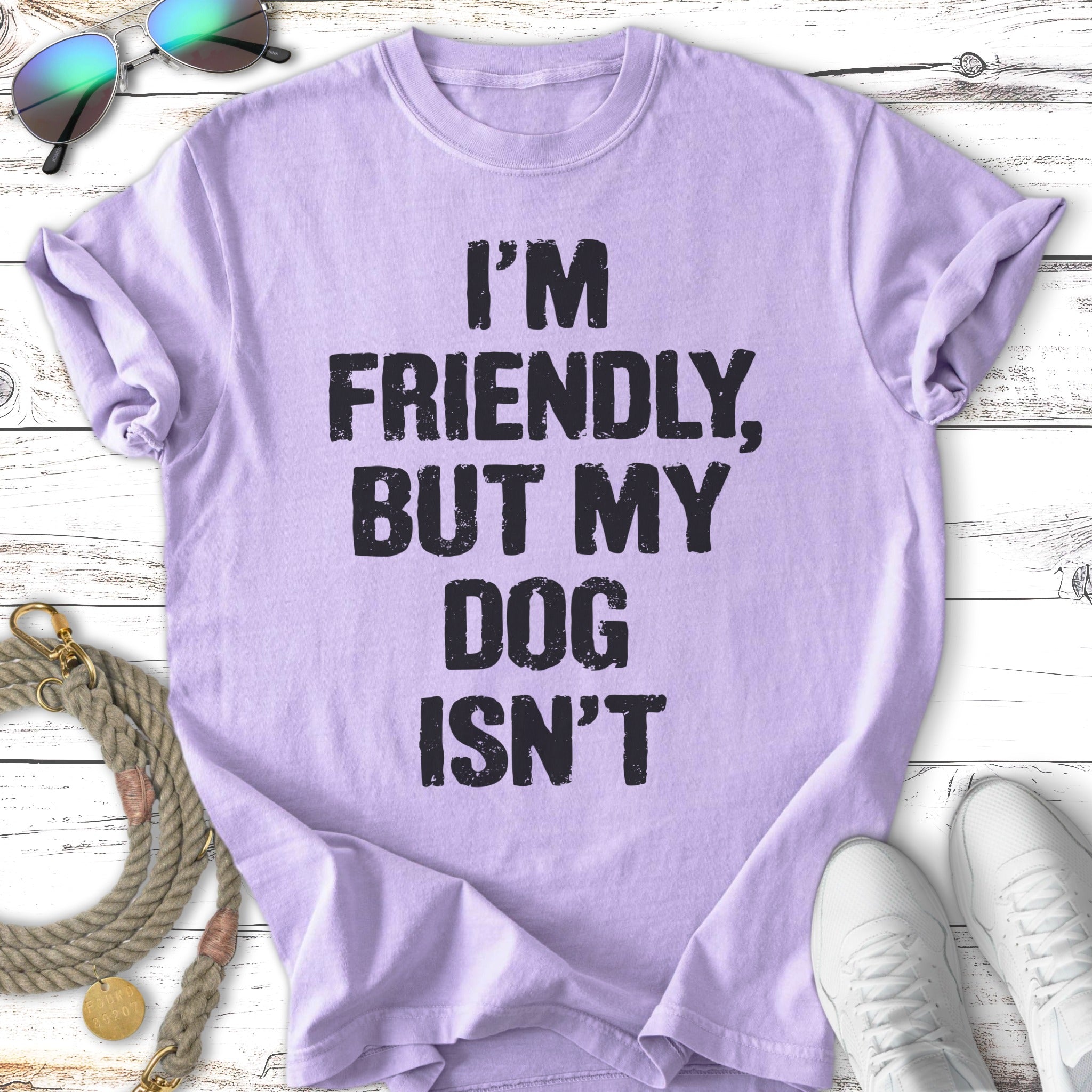 Lavender t-shirt with bold black text: "I'M FRIENDLY, BUT MY DOG ISN'T".