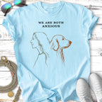 Light blue t-shirt with line drawing of a woman and dog profile, "WE ARE BOTH ANXIOUS" text.