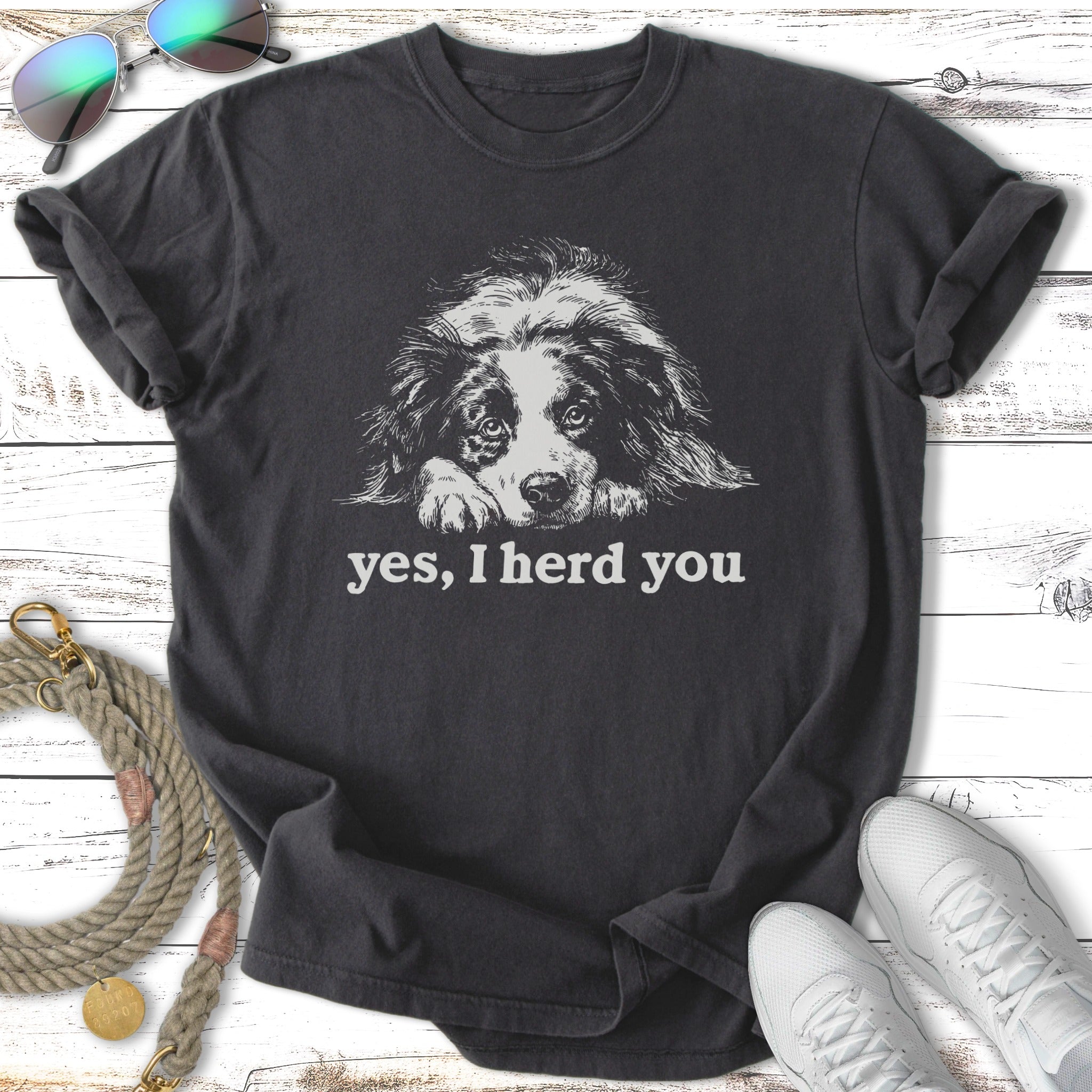 Dark t-shirt with a white line drawing of a dog's face and "yes, I herd you" text.