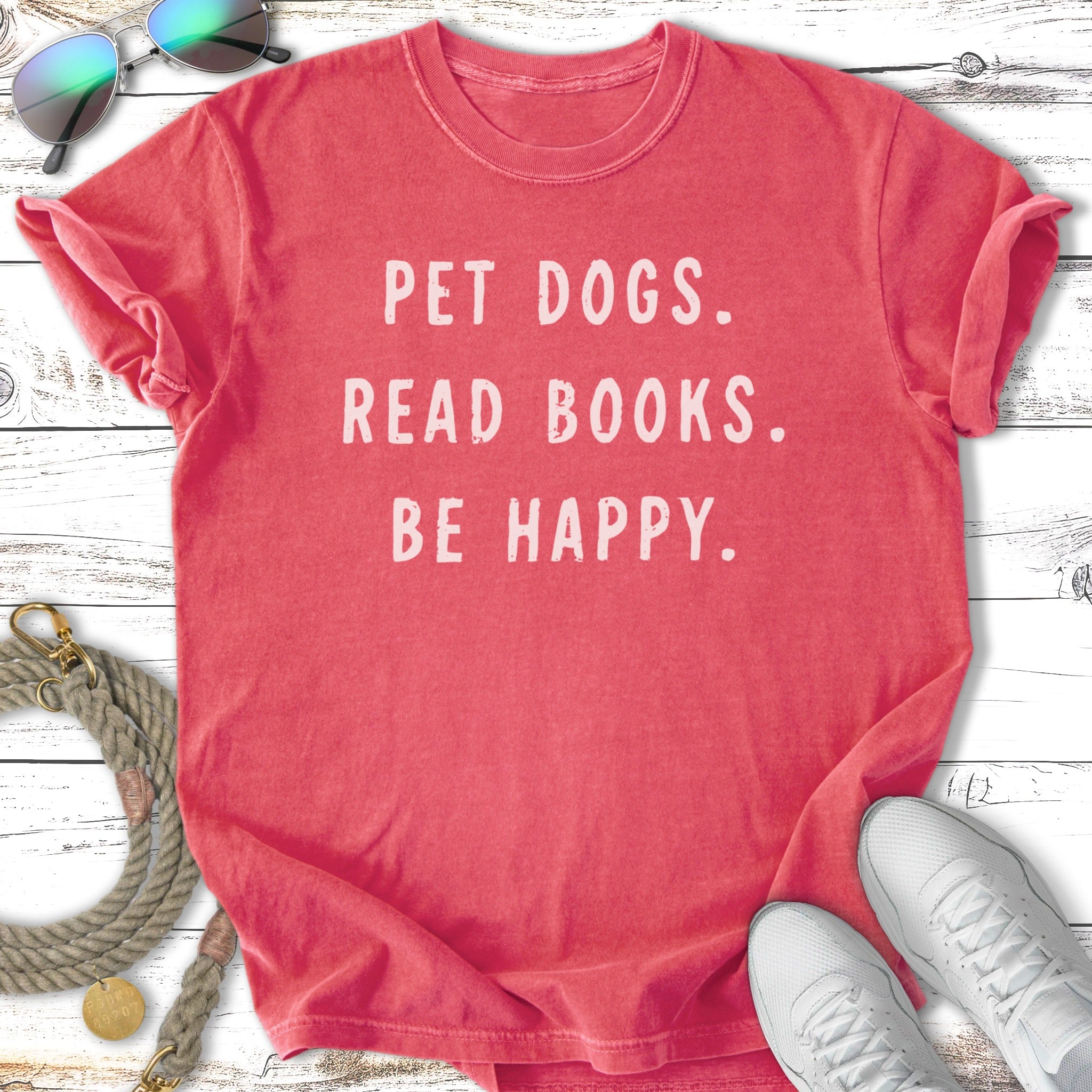 Coral t-shirt with "Pet Dogs. Read Books. Be Happy." text.