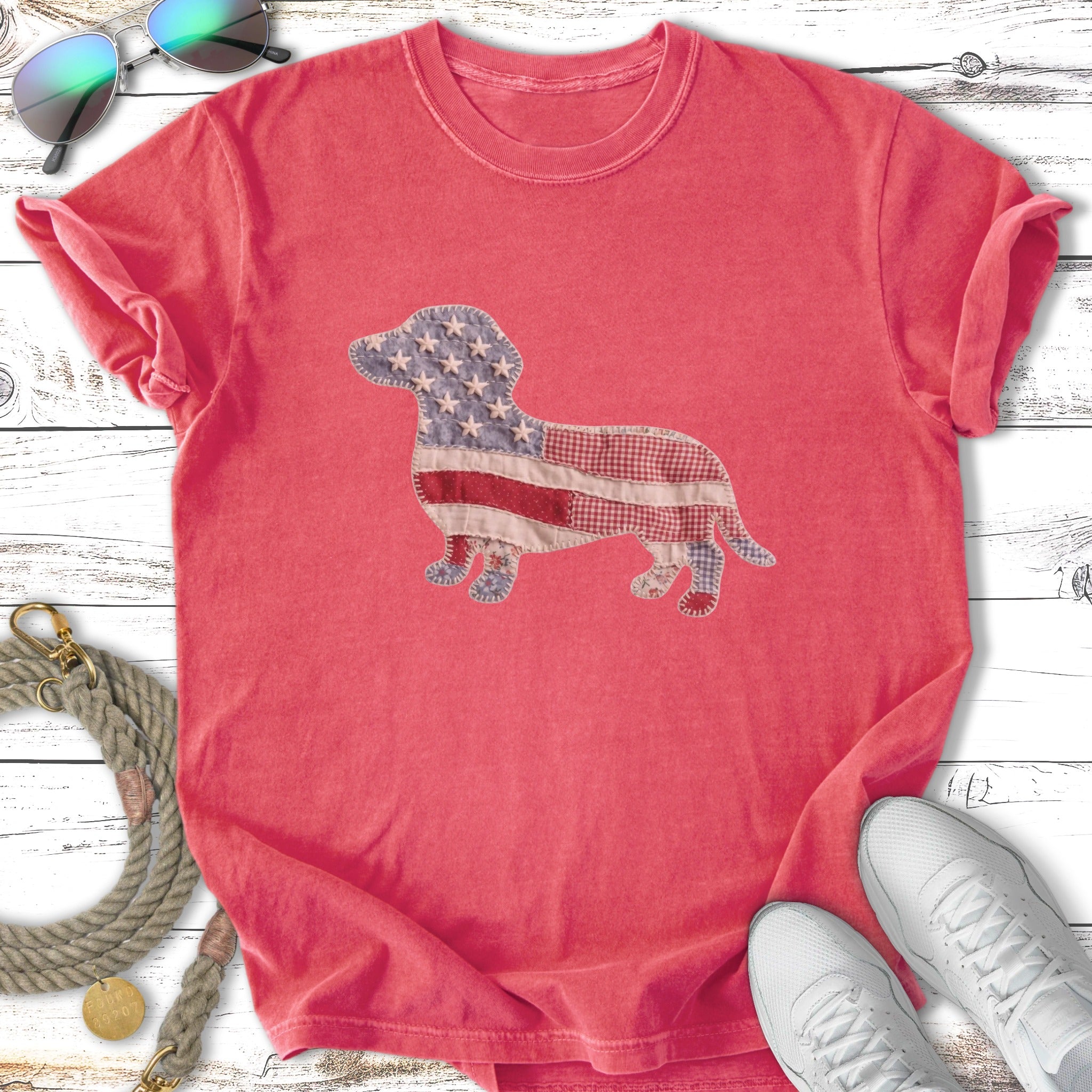 Red t-shirt with patriotic dachshund design and white sneakers.